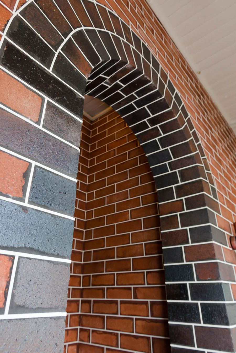 Brick arch with fresh white tuckpointing after repointing